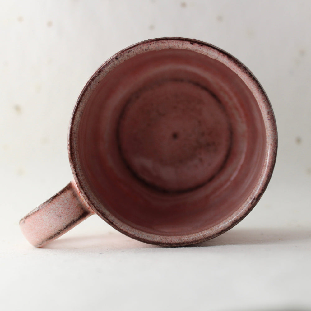 Pink ceramic mug on a light background