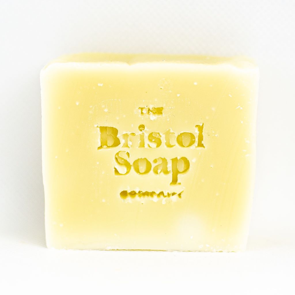 Bar of yellow soap with 'The Bristol Soap Company' branding on a white background